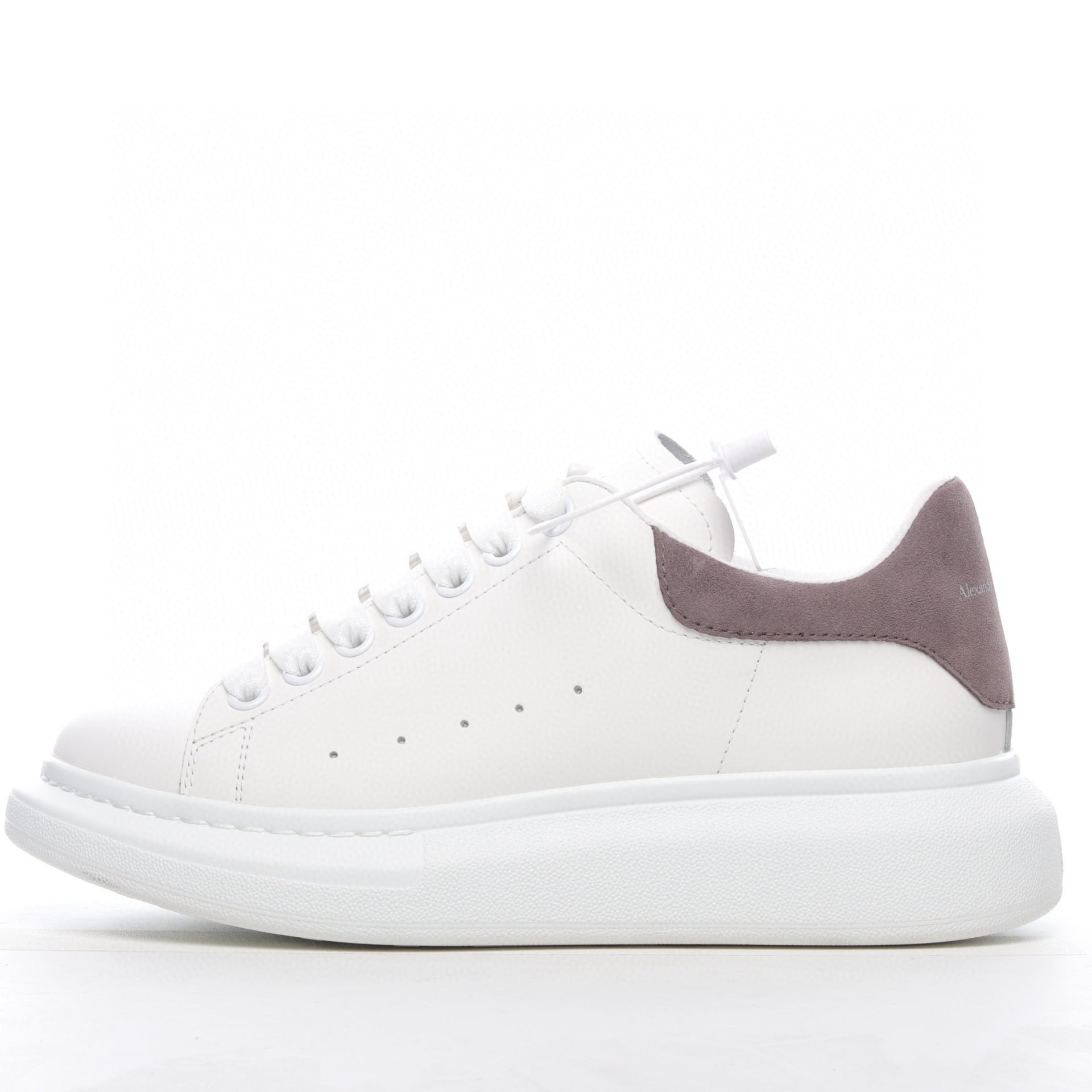 White sneaker with a purple heel on a white background