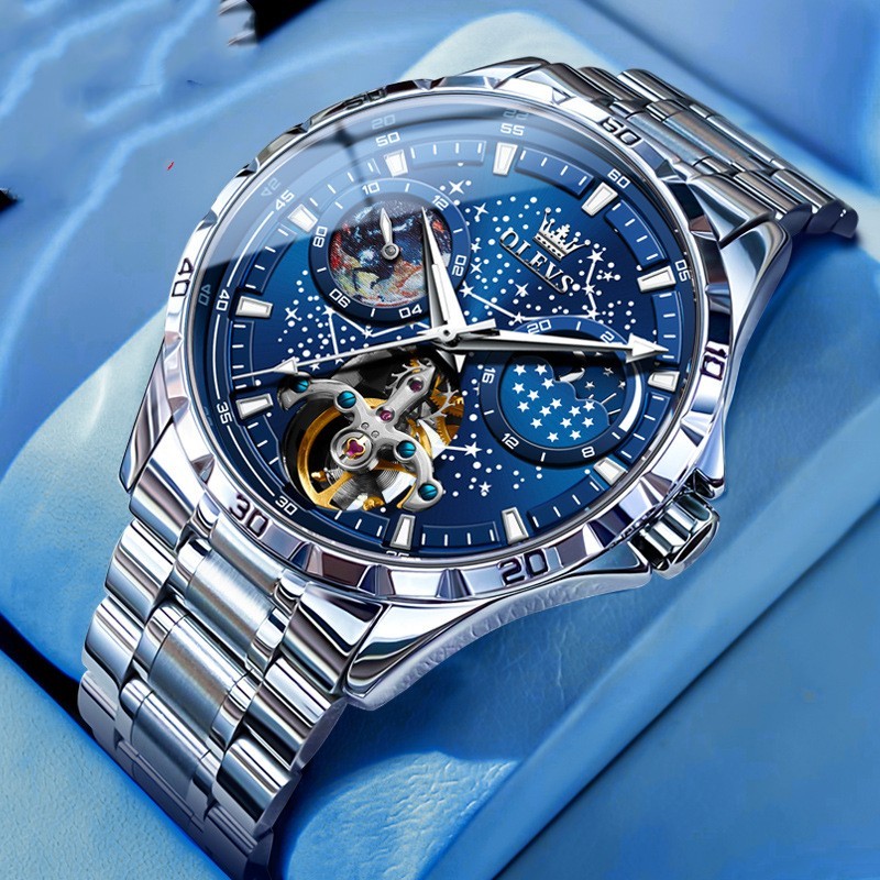 Luxury watch with blue face and silver metal strap on a blue background