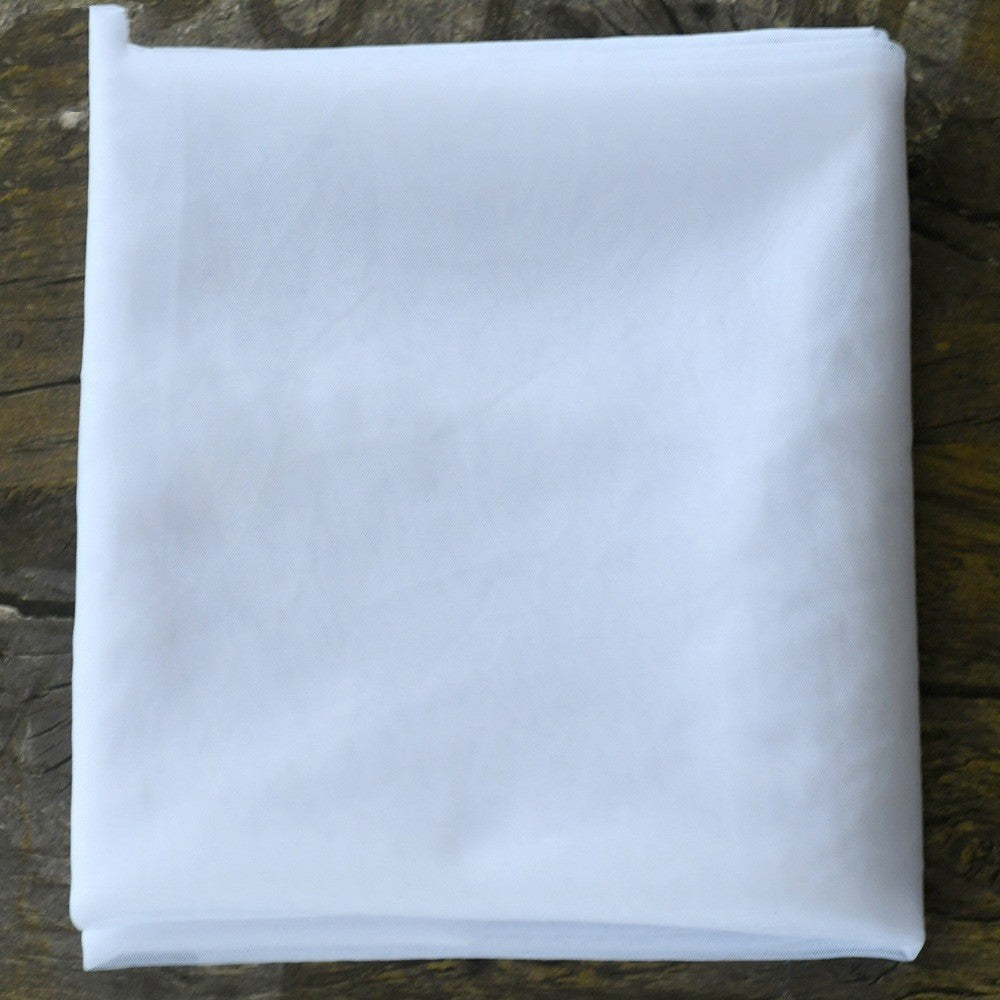 Folded white cloth on a wooden surface