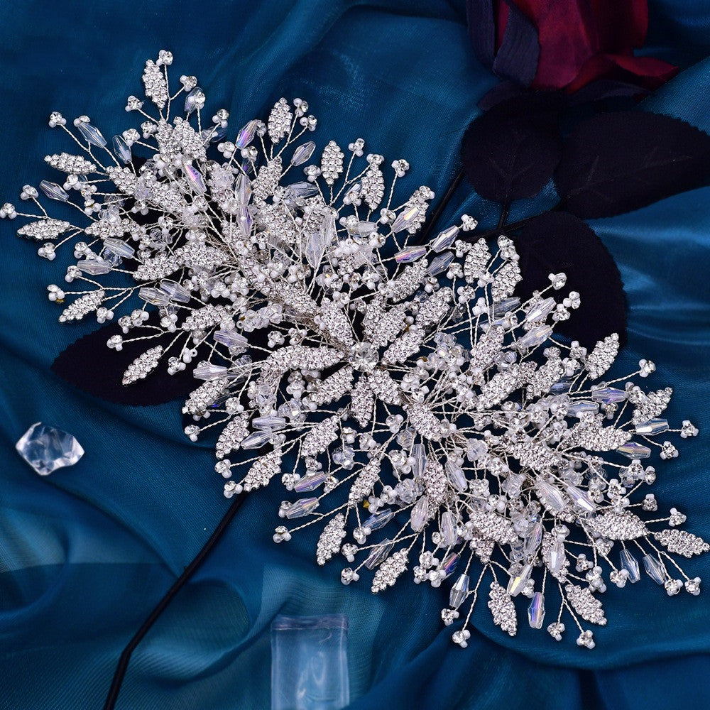 Decorative hairpiece with crystals on a blue fabric background