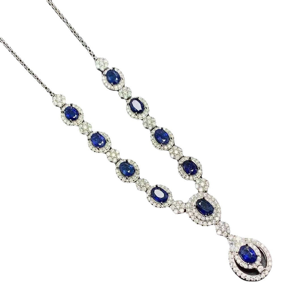 Elegant necklace with blue gemstones and white stones on a white background