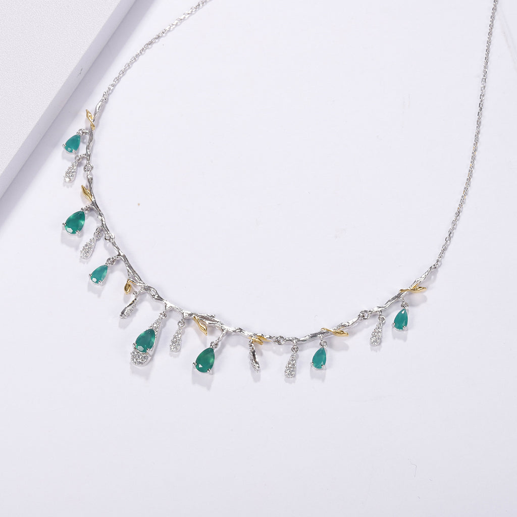 Necklace with green gemstones on a white background