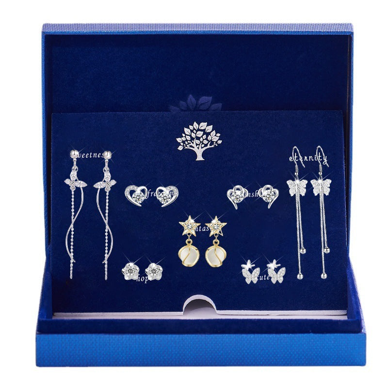 Set of silver earrings in a blue jewelry box