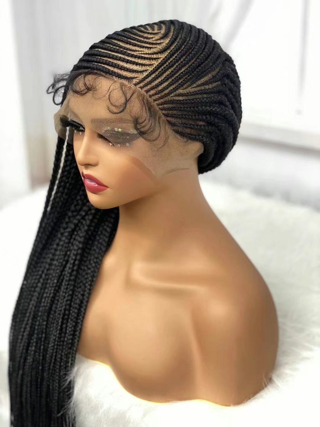 Mannequin head with a black braided wig on a white background