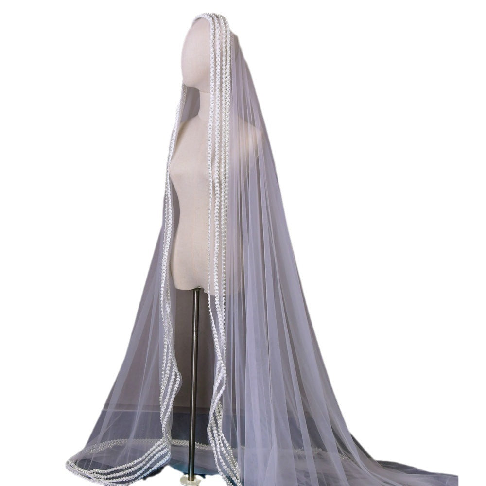 Gray wedding veil with lace trim on a mannequin against a white background