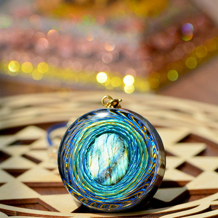 Decorative glass orb with blue and gold swirls on a woven surface