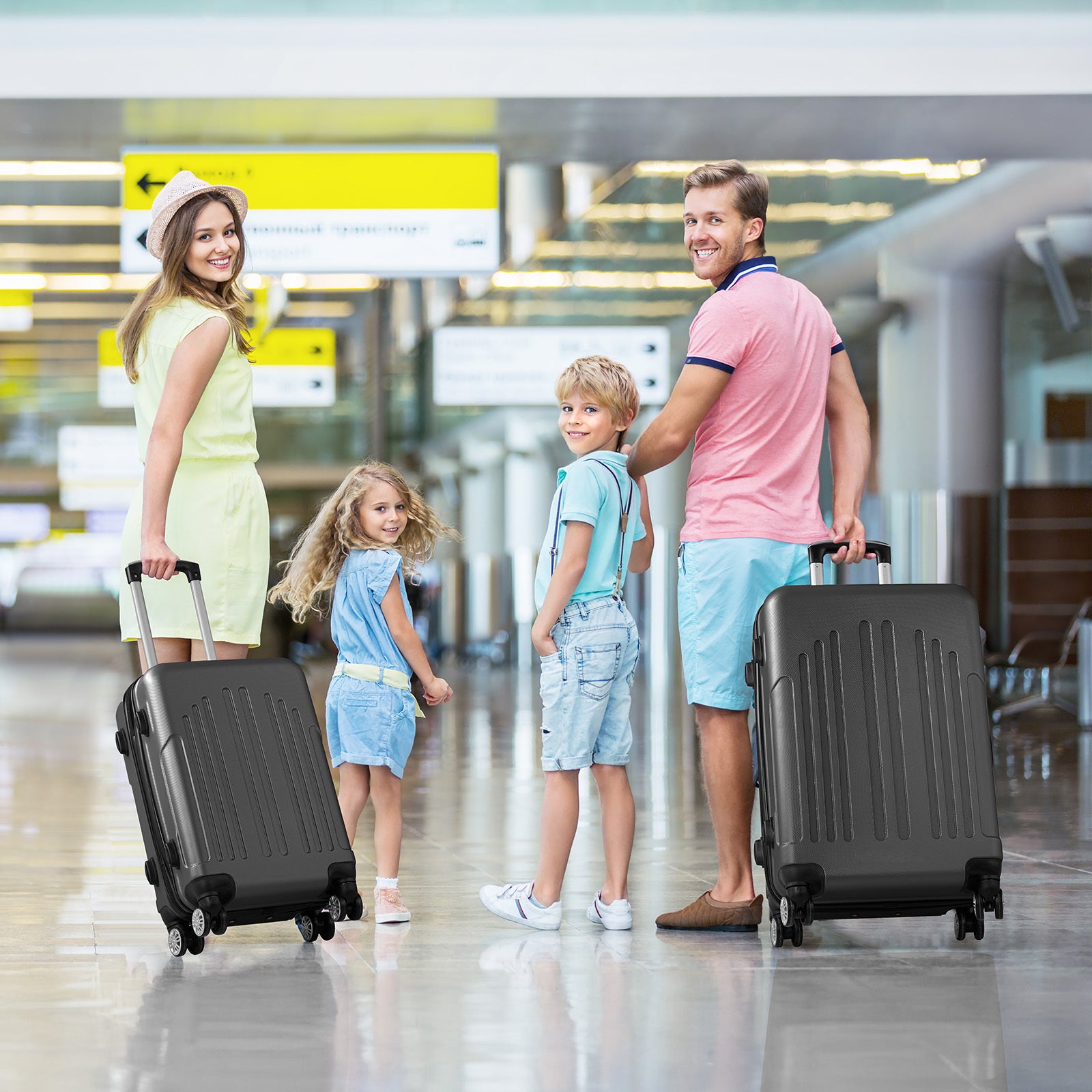 Family of four with luggage at an airport