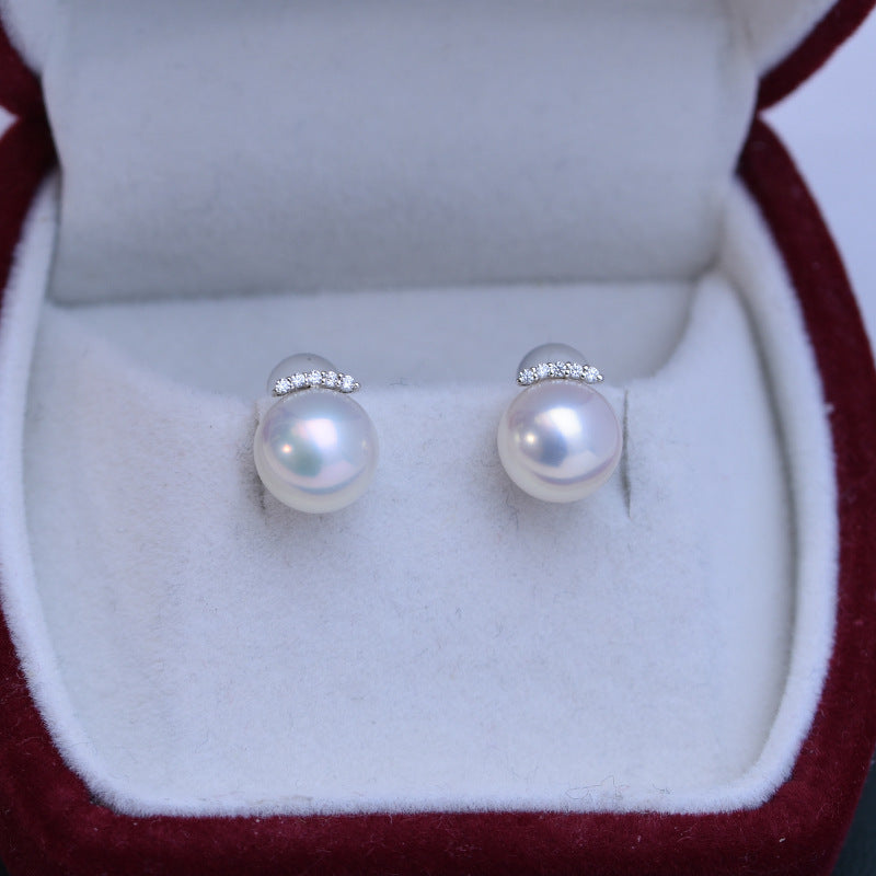 Pearl earrings with silver studs in a jewelry box