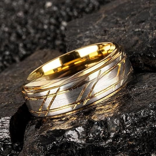 Gold and silver ring on a dark stone surface