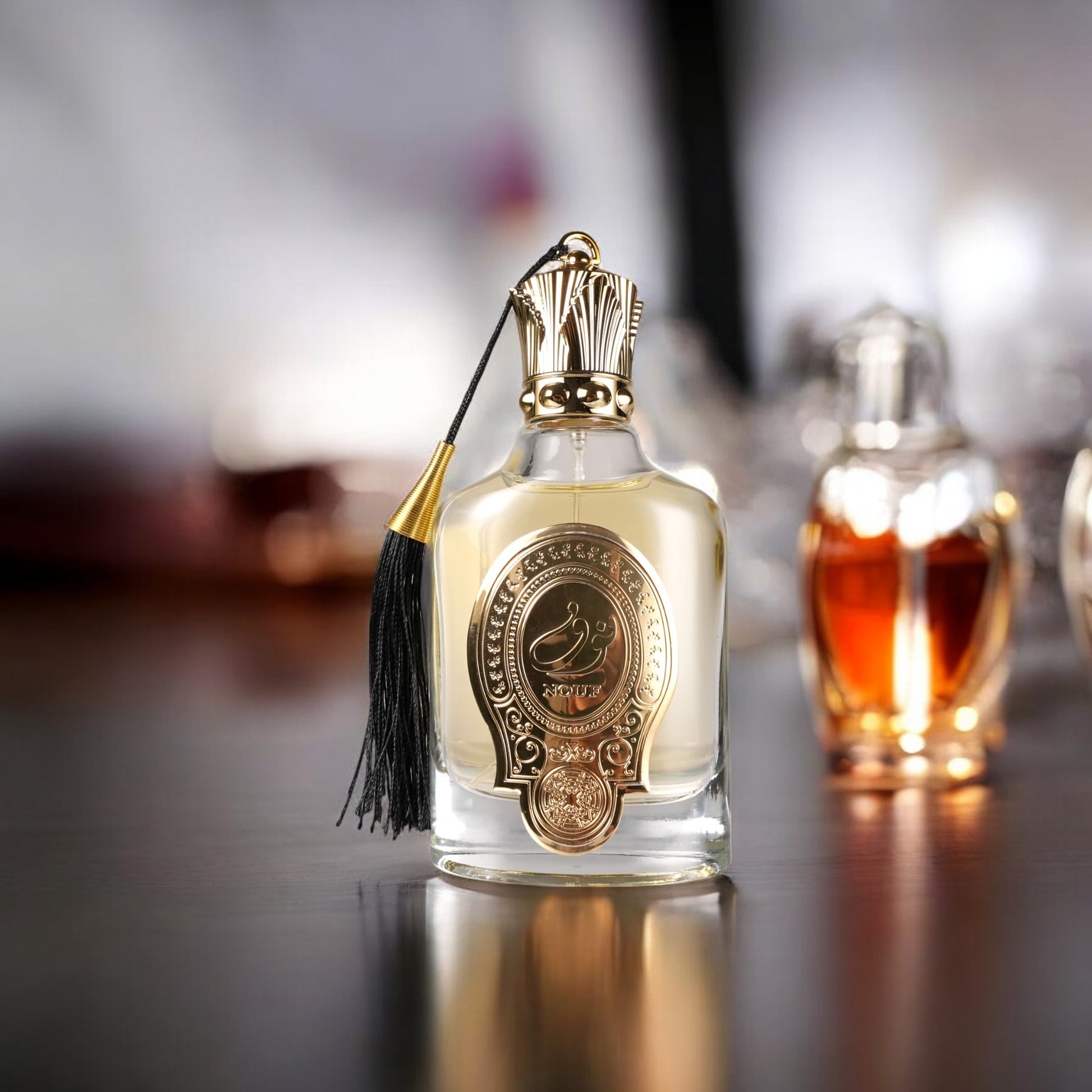 Perfume bottle with gold cap and decorative label on a reflective surface