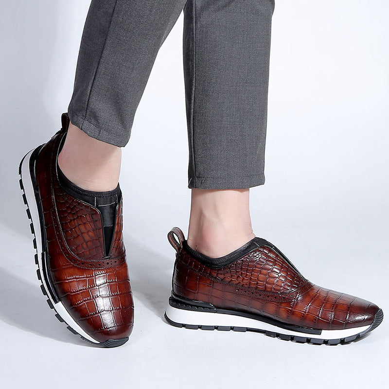 Brown leather shoes with a textured pattern worn by a person on a white background