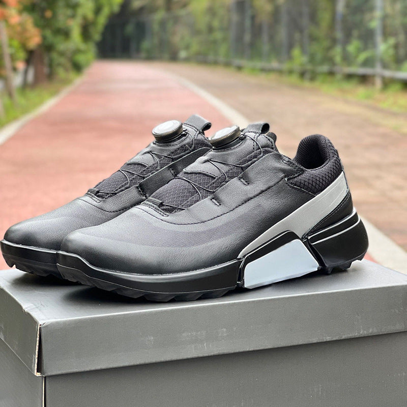 Gray and black athletic shoes on a box with a blurred outdoor background