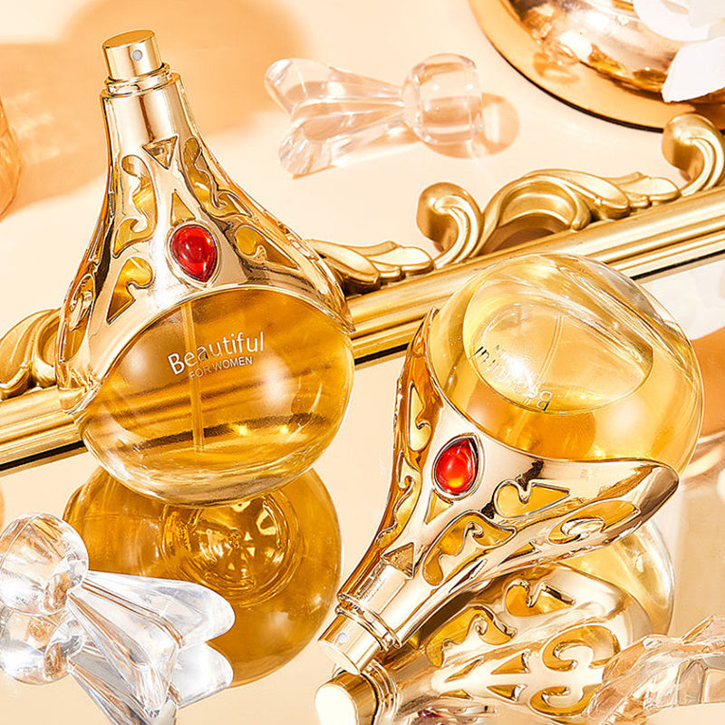 Gold perfume bottle with decorative elements on a reflective surface