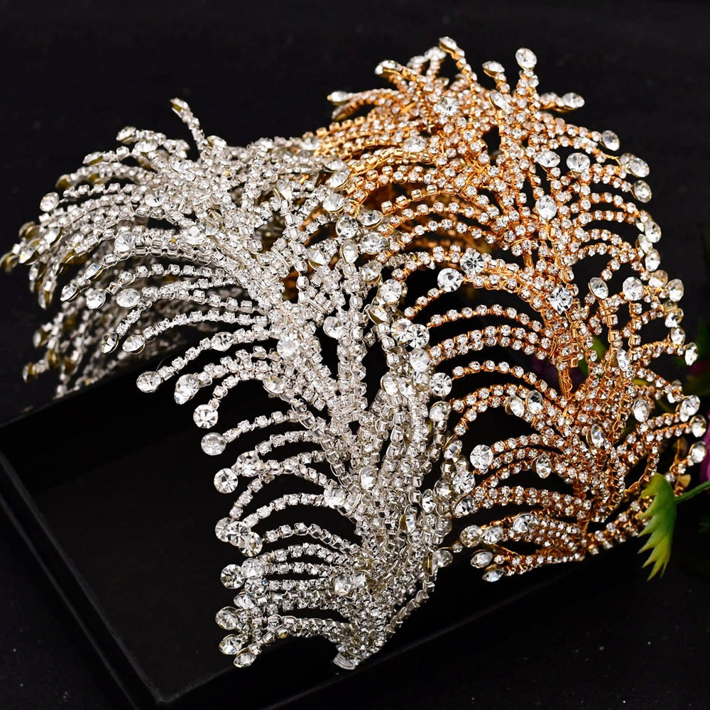 Decorative headpiece with gold and silver feather-like designs on a black background