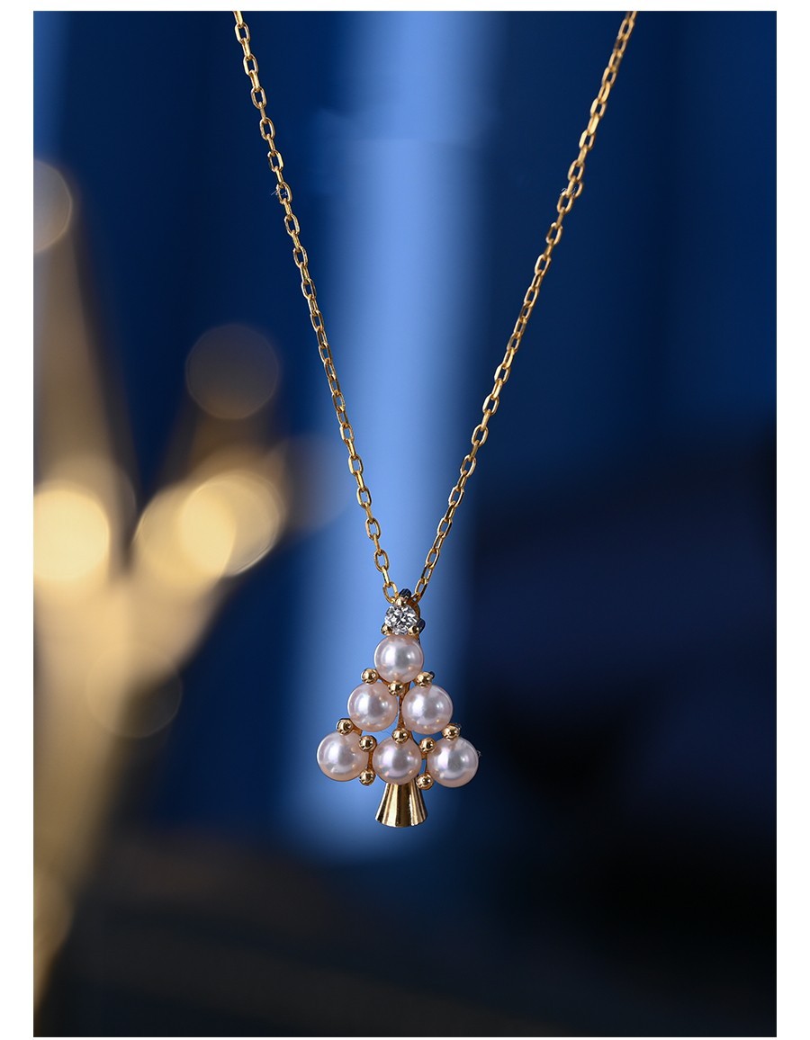 Pearl necklace with gold chain on a dark blue background