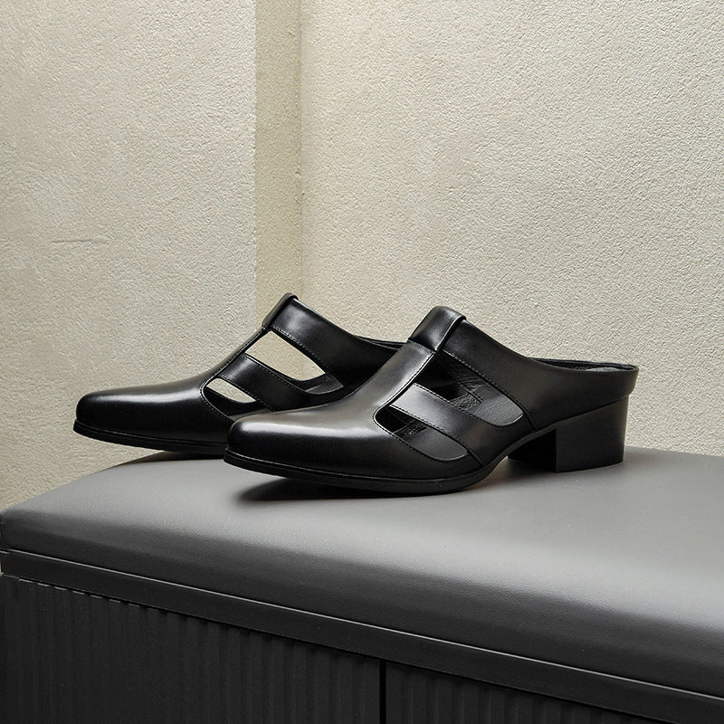Black leather clogs on a gray surface with a neutral background