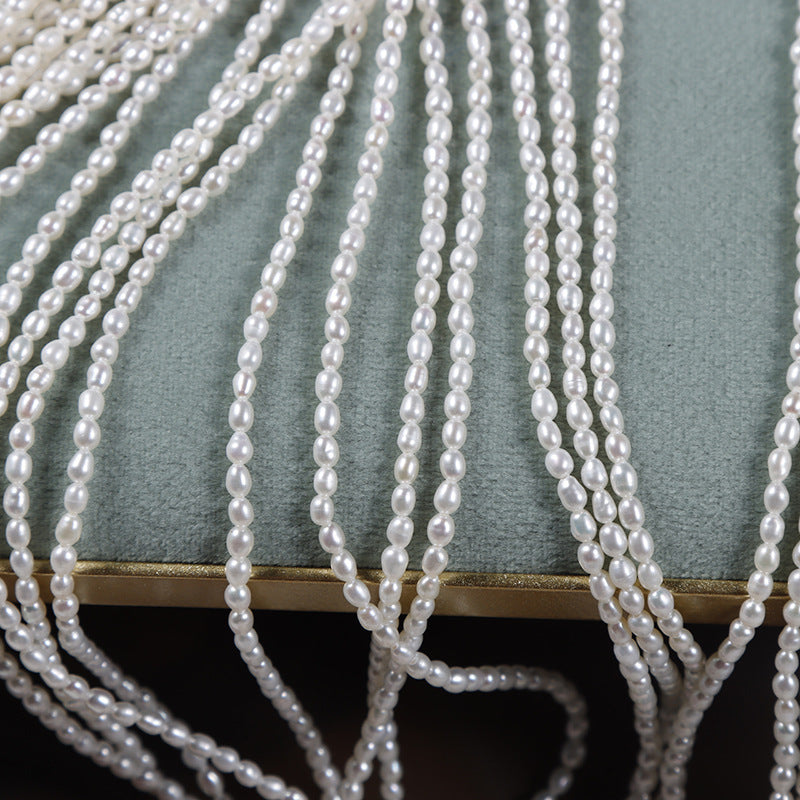 Close-up of pearl strands draped over a textured surface