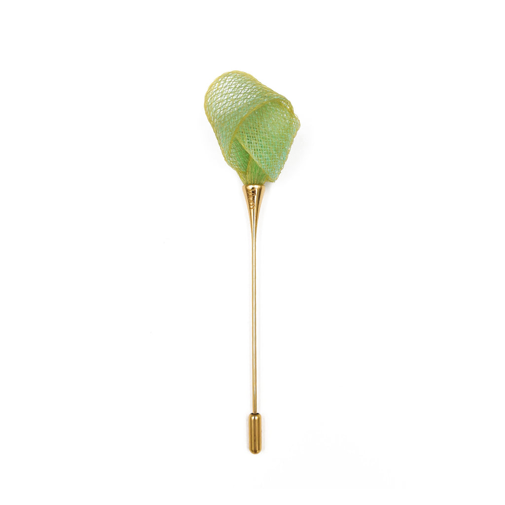 Green butterfly net with gold handle on a white background