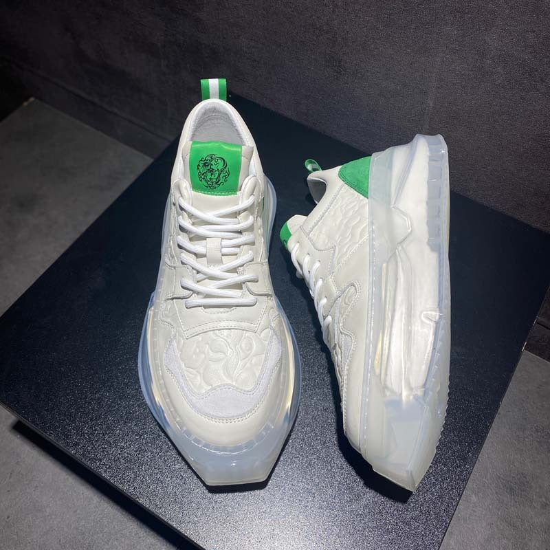 White sneakers with green accents on a dark surface