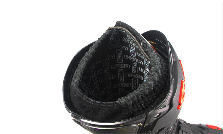 Close-up of a black motorcycle boot with brand logo on the back, on a white background