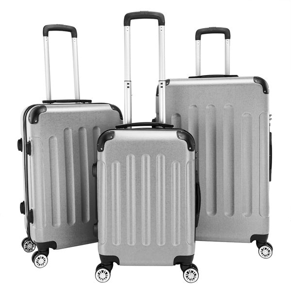 Set of three silver suitcases with black wheels on a white background