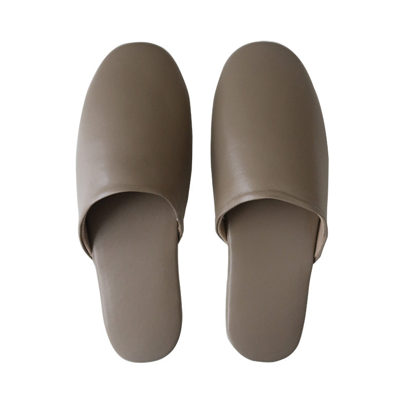 Pair of beige slippers on a white background