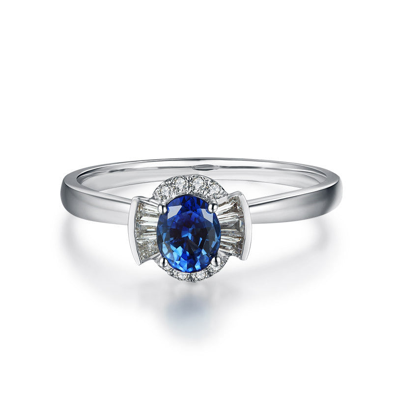 Silver ring with a blue gemstone on a white background