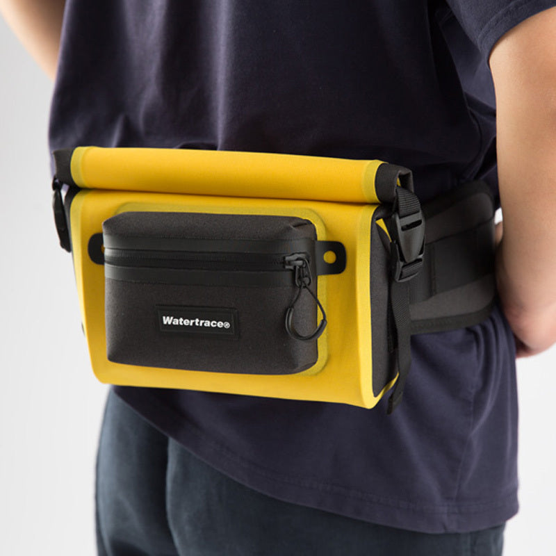 Person wearing a yellow waist bag with a black pocket, featuring the Watertrace brand.