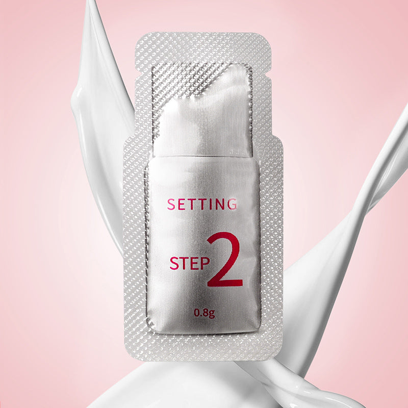 Silver packaging labeled 'Step 2' on a pink background