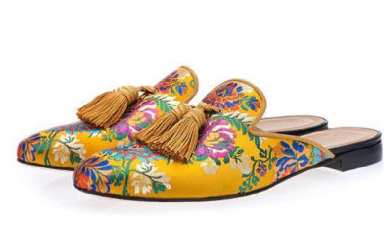 Colorful floral slippers with tassels on a white background