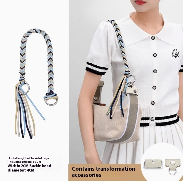 Strap with tassel and buckle, worn by a person in a white outfit, on a plain background.