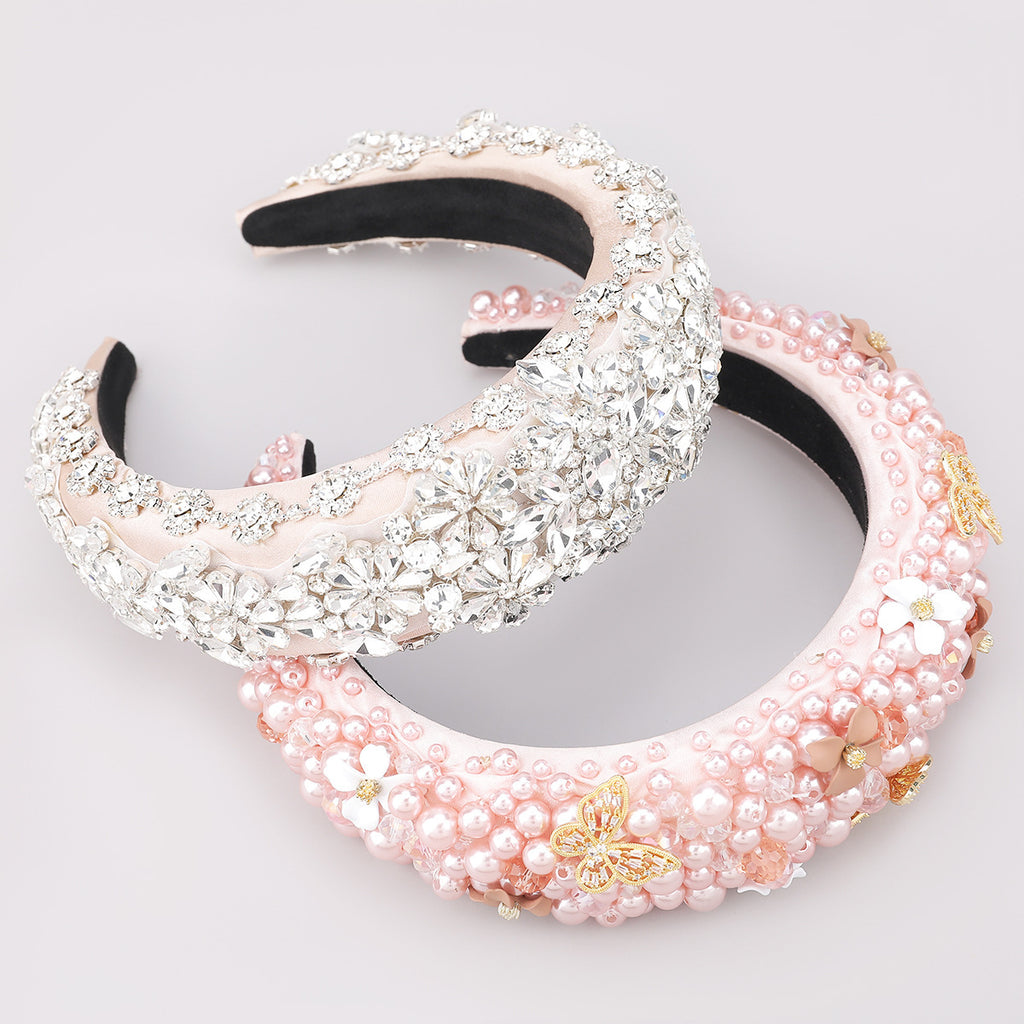 Two decorative headbands, one with pink pearls and the other with silver embellishments, on a light gray background.