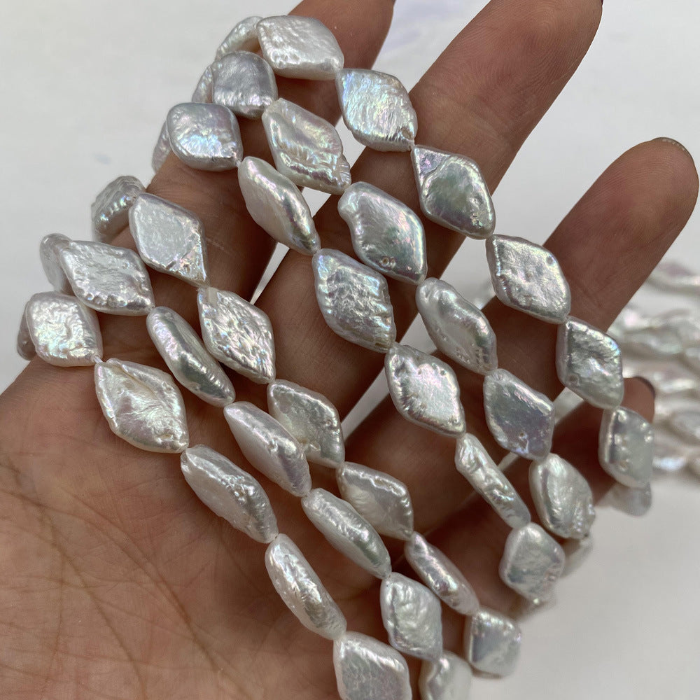 Pearl necklace held in a hand against a white background