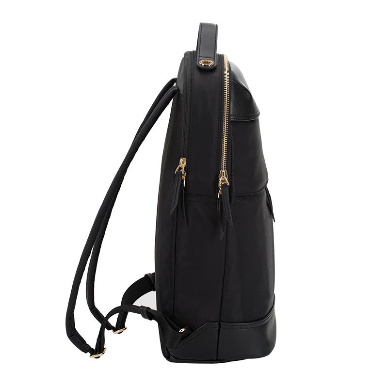 Black backpack with gold zippers on a white background
