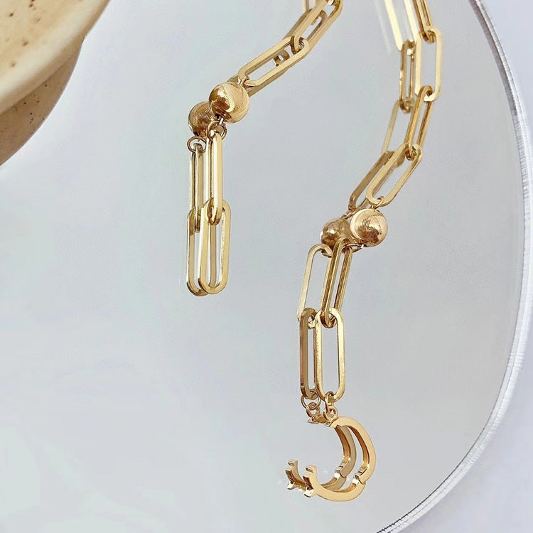 Gold chain necklace on a light gray background