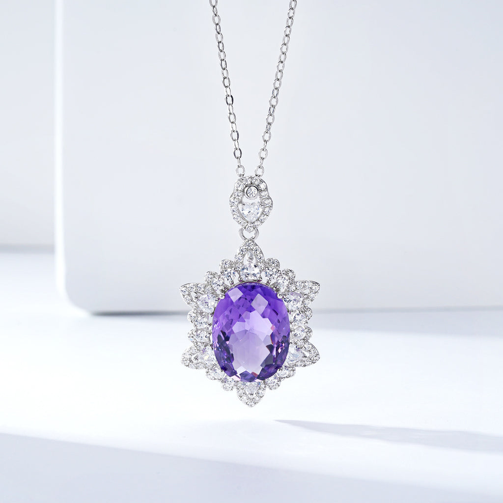 Purple gemstone pendant on a chain against a light background