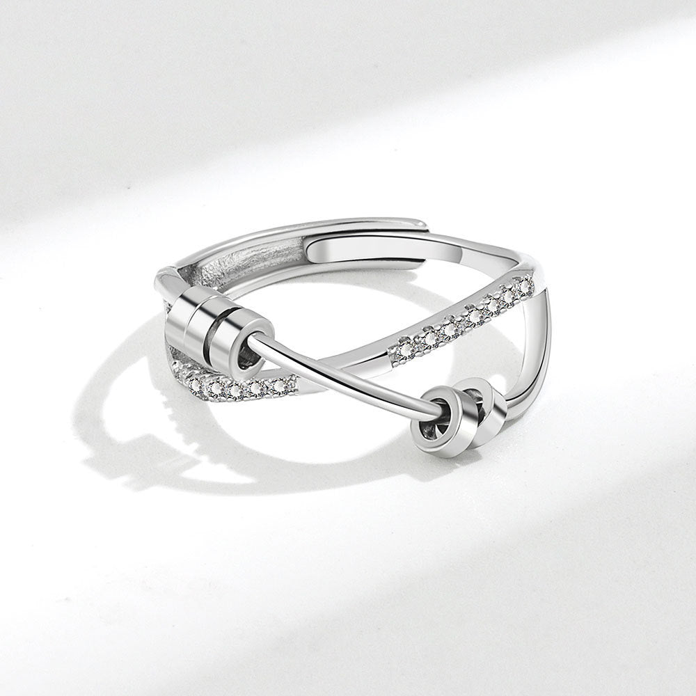 Silver ring with diamond accents on a white background