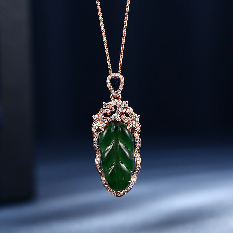 Green jade pendant with gold frame on a dark background
