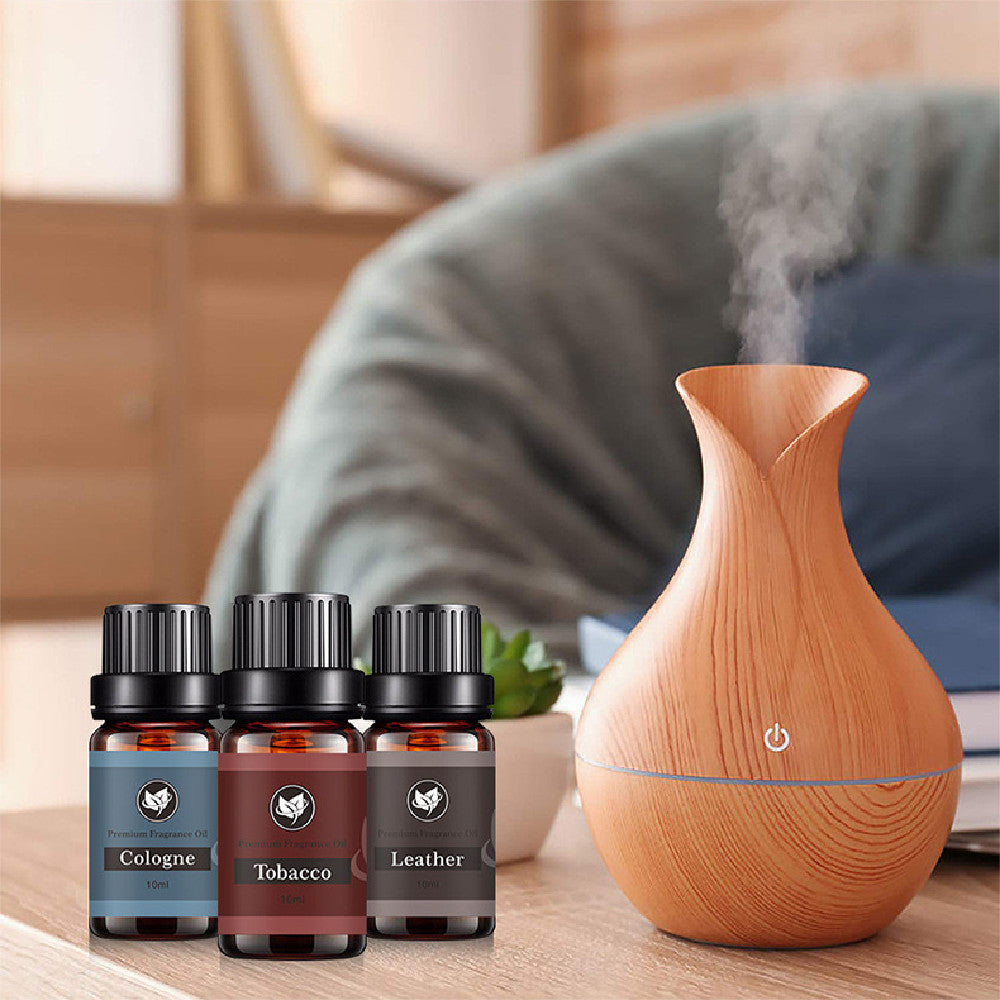 16 Theme Atmosphere Flameless Essential Oil Sets with diffuser and three essential oil bottles on wooden table