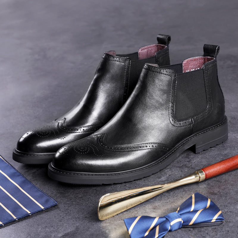 Black leather shoes with a shoe brush and blue bow tie on a gray background