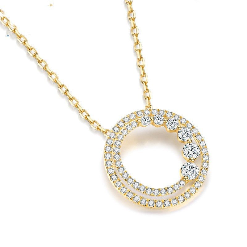 Gold necklace with a circular pendant on a white background