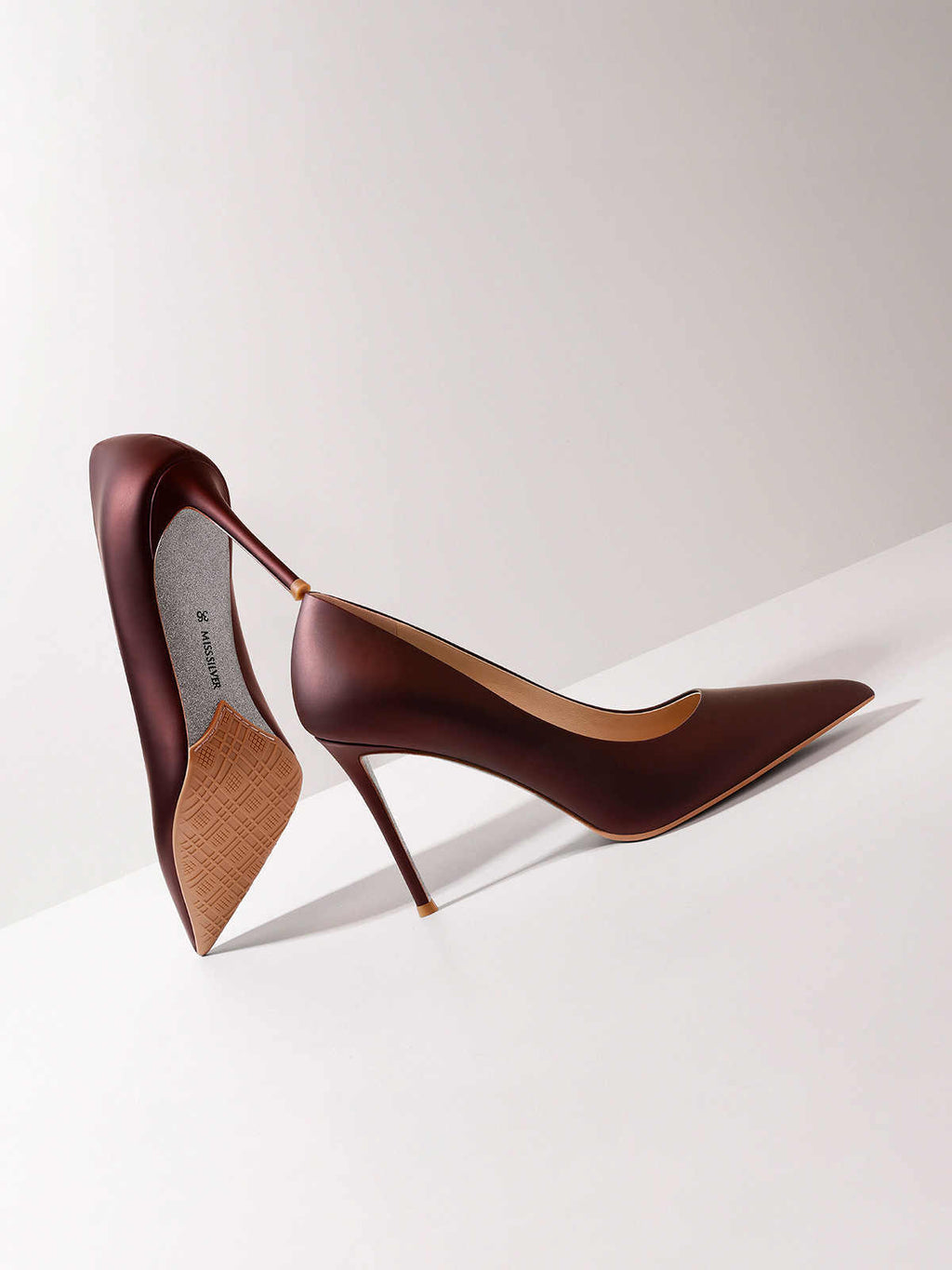 Brown high-heeled shoes on a white background