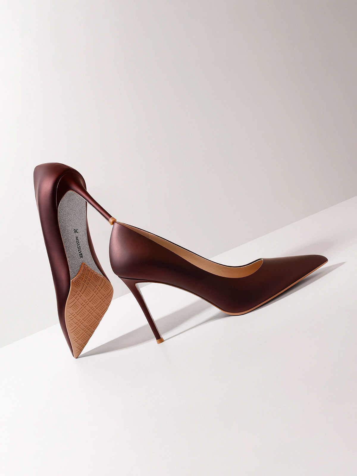 Brown high-heeled shoes on a white background