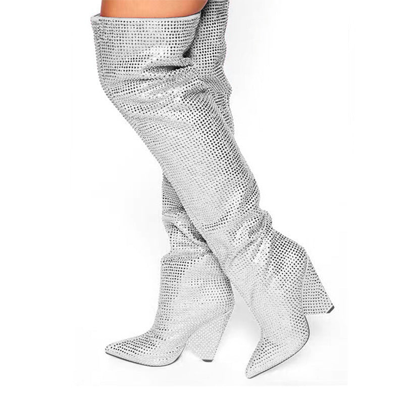 Silver sequin knee-high boots on a white background