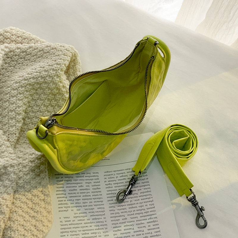 Yellow waist bag with strap on a book with a white background