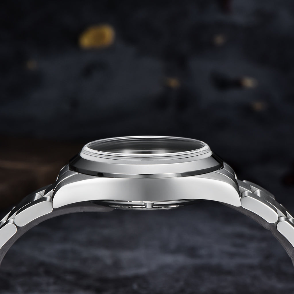 Close-up of a silver watch case on a dark textured background