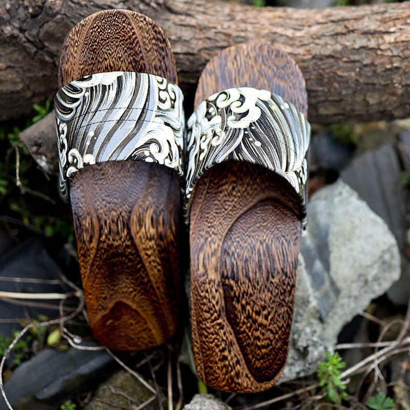 Wooden sandals with decorative straps on a natural background