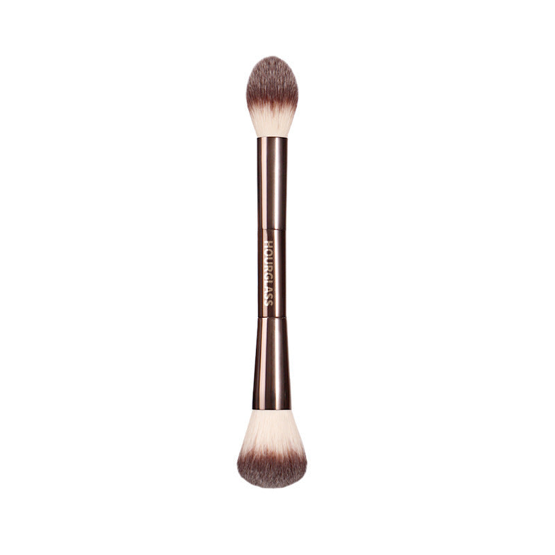 Makeup brush with a brown handle on a white background