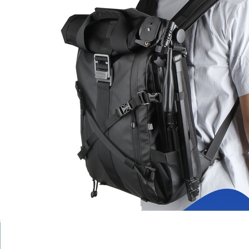 Black backpack worn by a person on a white background