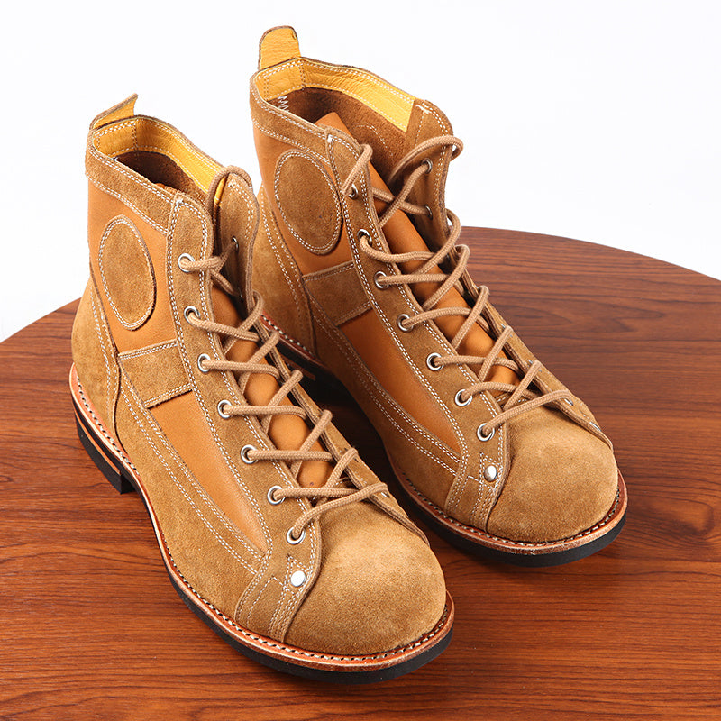 Pair of brown leather boots on a wooden surface